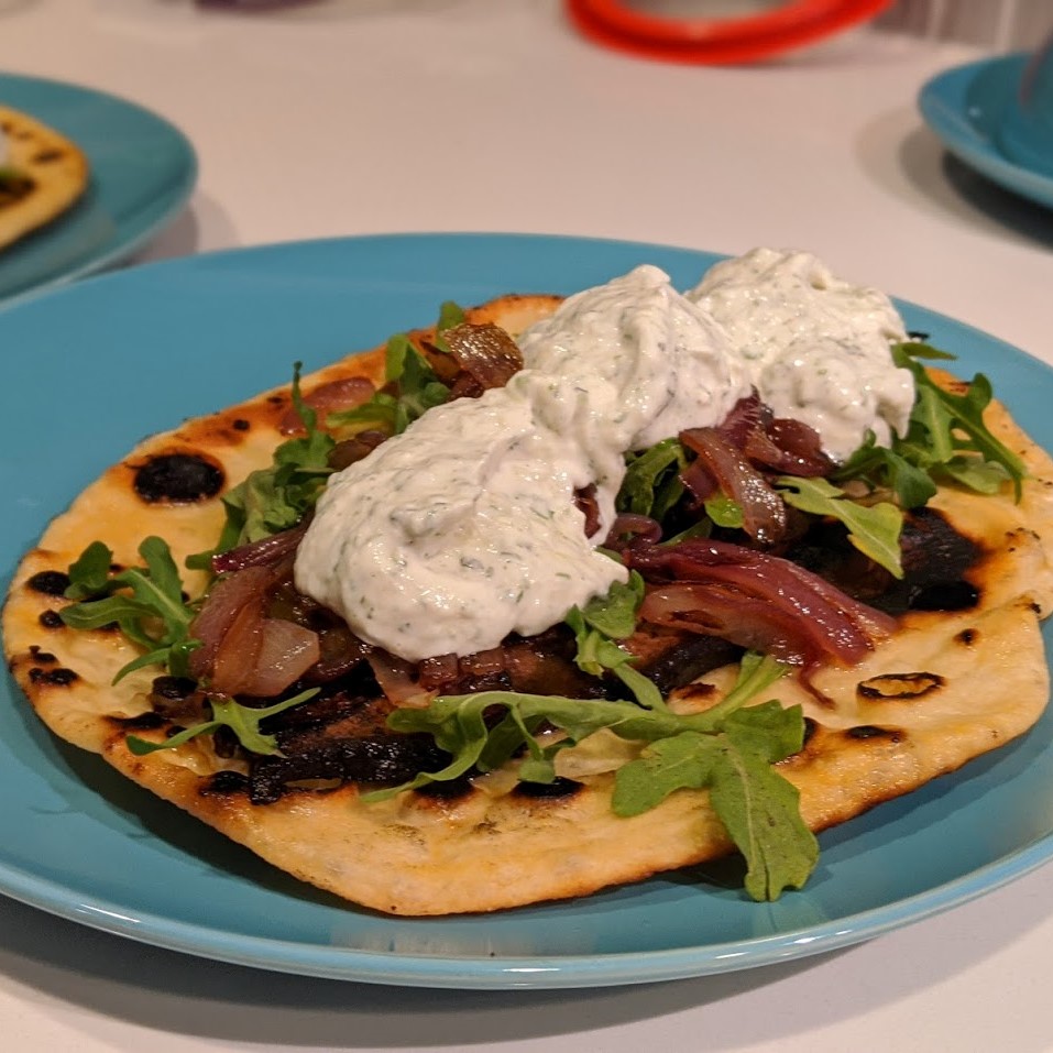 Gyros with homemade pita, homemade tzatziki, mushrooms, onion, and arugula